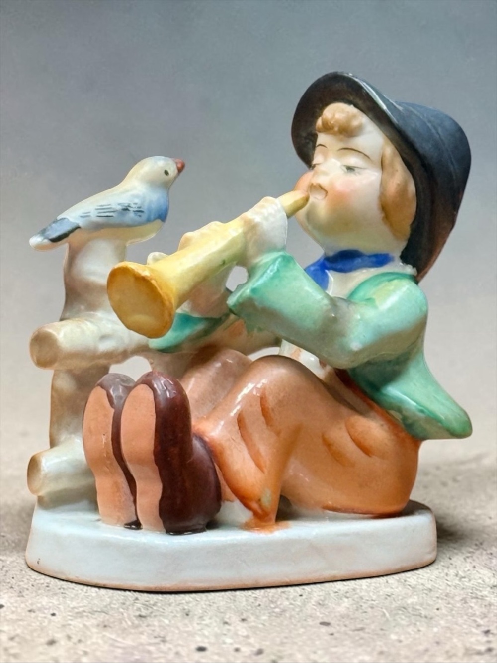 Figurine of Boy Playing Horn